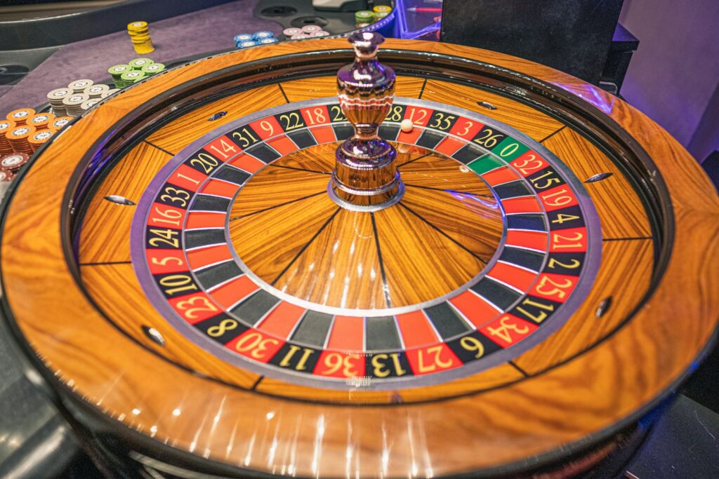 Close-up of a wooden roulette wheel on a casino table